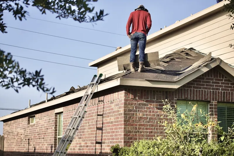 Professional roofer working on a residential roof in Montgomery Crossing